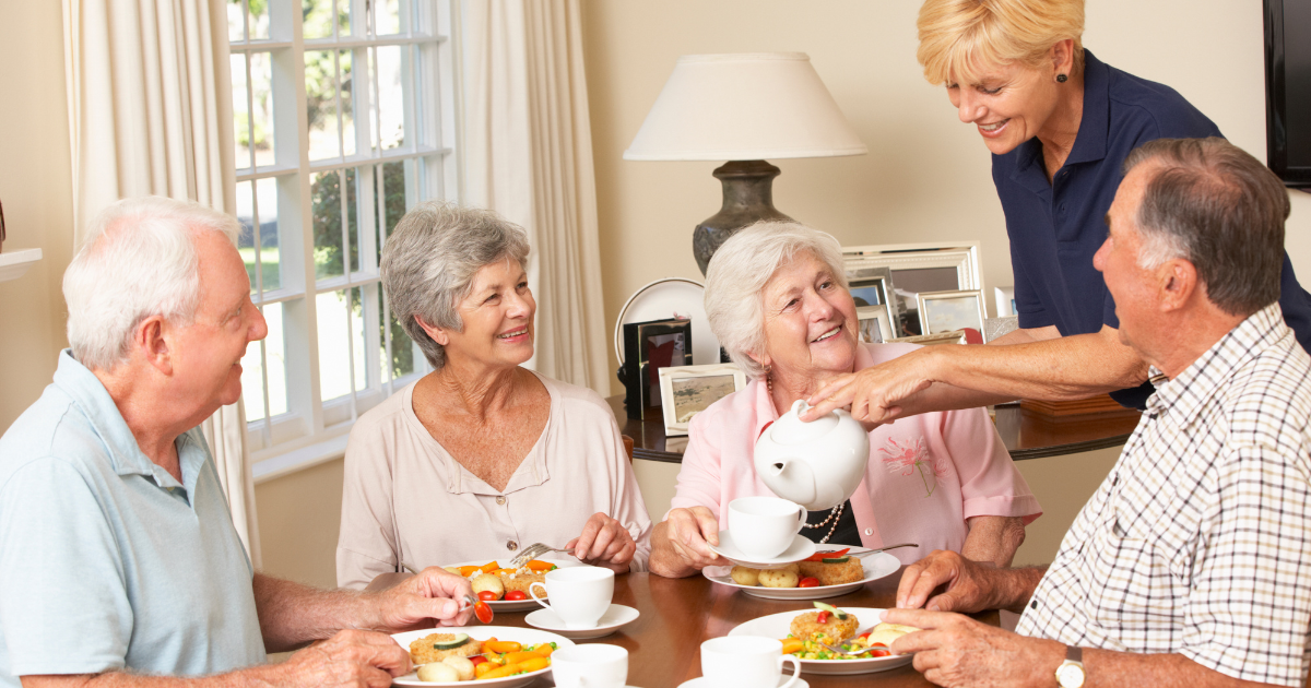 What's the Difference Between an Adult Family Home and Assisted Living Home? - seniors enjoying meal together in residential care adult family home